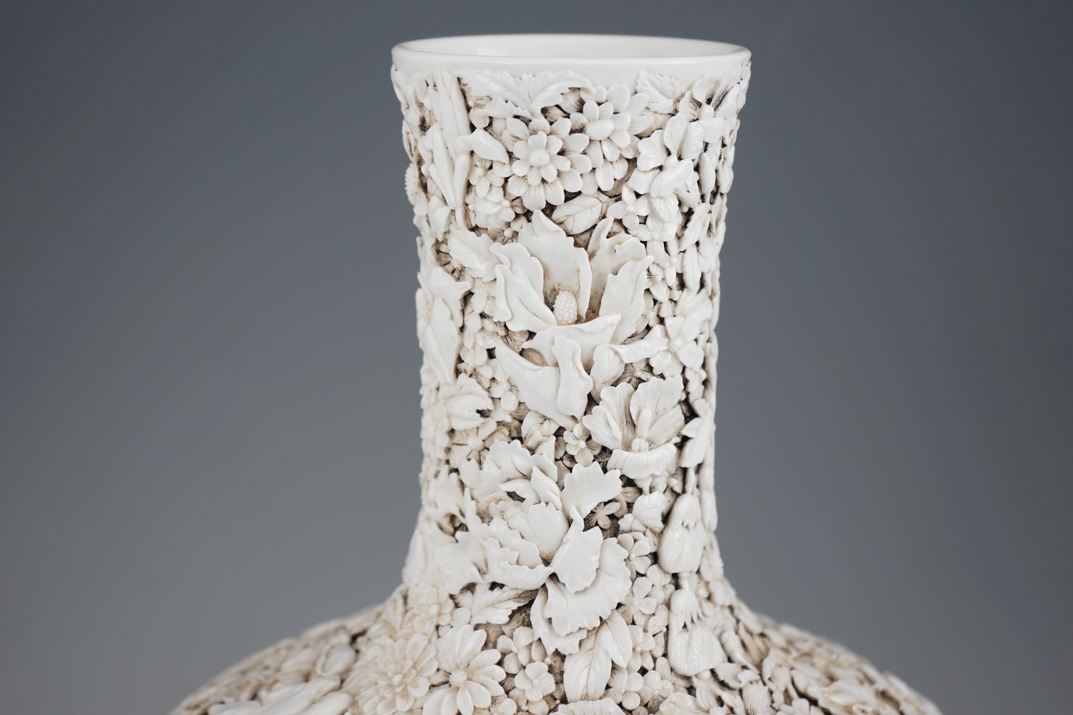 A large Chinese carved porcelain ‘thousand flower’ bottle vase, 20th century